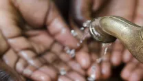 Hands under a tap with running water