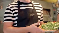 PizzaExpress chef holding a pizza