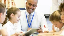 teacher in class with tablet