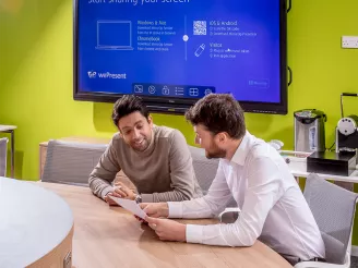 Discussion between two professionals in bright meeting room