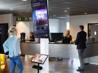 Various screens in busy office reception