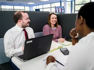 Additional IT Support personnel having a team meeting