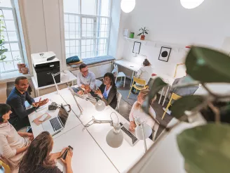 Small business meeting with laptops and printers