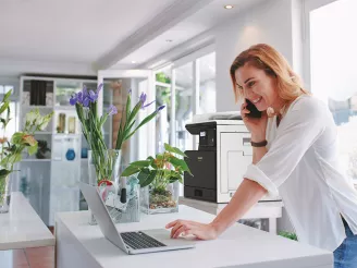 Florist on phone and laptop