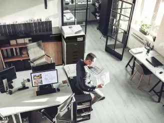 Man reviewing printed plans in office