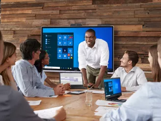 Team meeting in modern boardroom with interactive screen