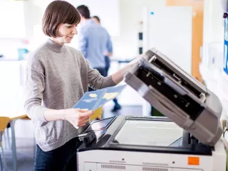 Woman using colour photocopier