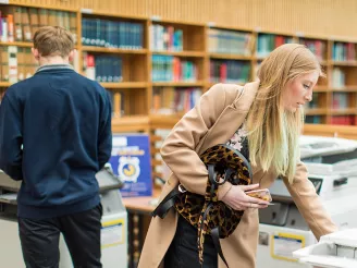 Students collecting documents from printers