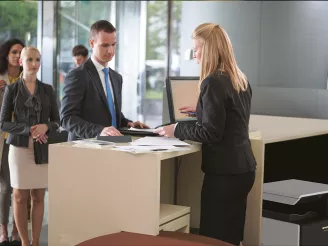 Customers at hotel reception desk