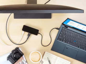 A laptop connecting to a docking station and monitor