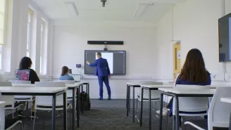 Teacher Writing on Interactive Display