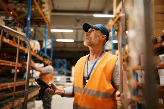 scanning packages while working at distribution warehouse.