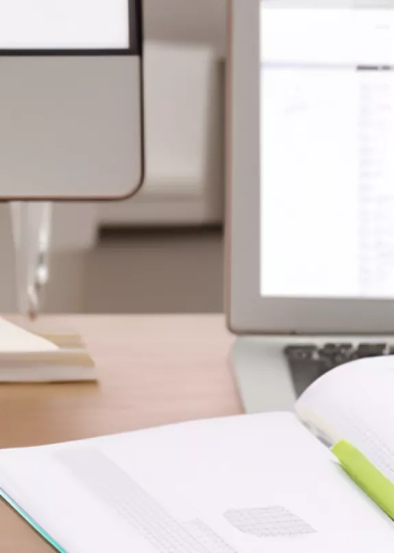 Person holding phone showing hot desking app