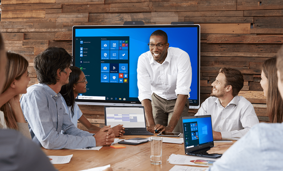 Team meeting in modern boardroom with interactive screen