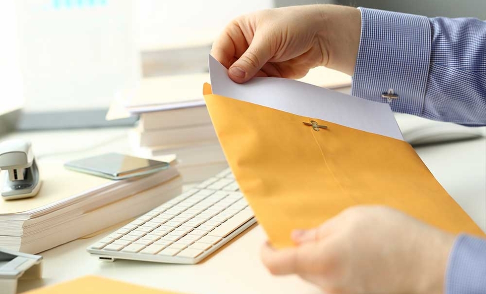 Man opening a letter - Hybrid mail