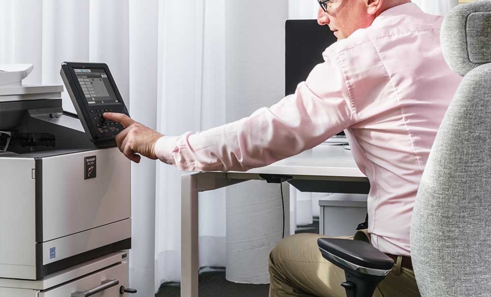 Man using all-in-one / multifunction printer