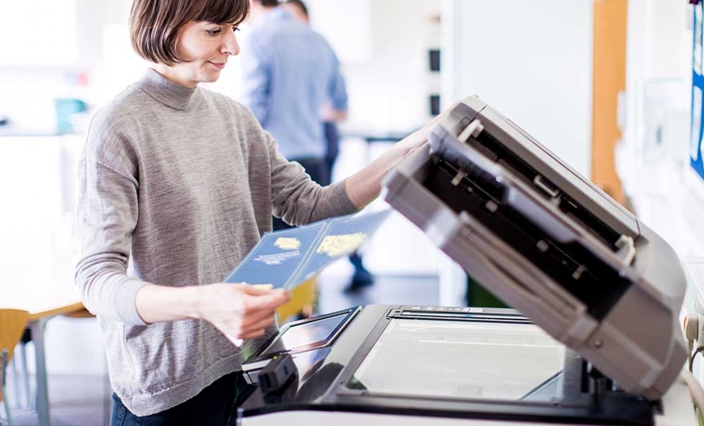 Woman using printer - print audit services