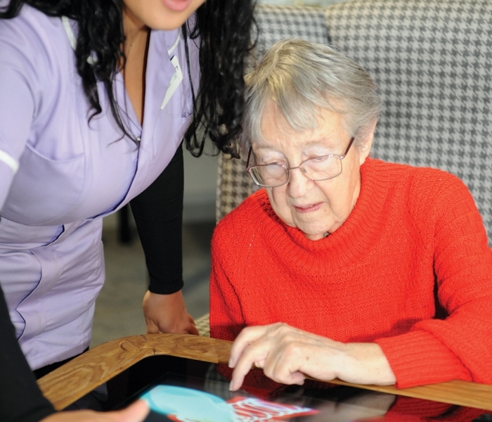 An image of an Interactive Touchscreen Table being used at New Care.